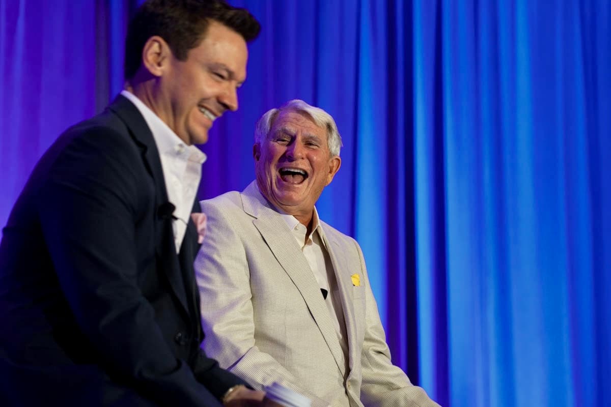 Dr. Brumm and Dr. Strupp laughing on stage during a candid moment at the Simplifying Complex CE seminar