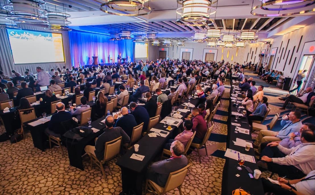 Wide view of the packed ballroom of attending dentists during a Simplifying Complex CE seminar in Clearwater, Florida